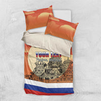 Personalized red bedding set, duvet with city graphic and two orange pillows with blue stripe