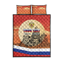 Red quilt bed set with two orange pillows; Russian flag border and skyline text design