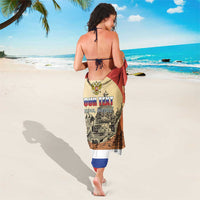 Red personalized sarong worn over legs, 'YOUR TEXT' and skyline graphic on back