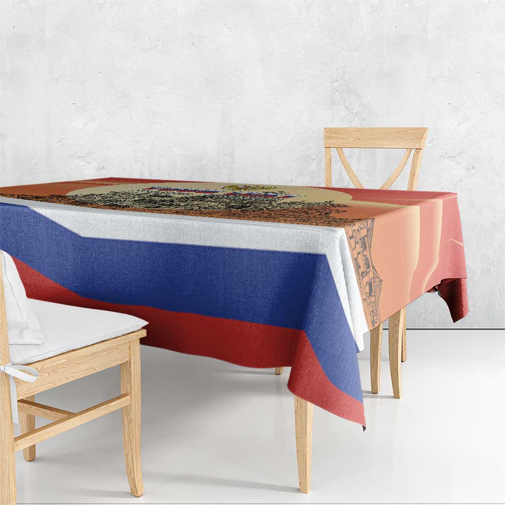 Red and blue striped Russia Day tablecloth with cityscape print, draped over table edge