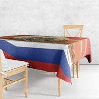 Red and blue striped Russia Day tablecloth with cityscape print, draped over table edge
