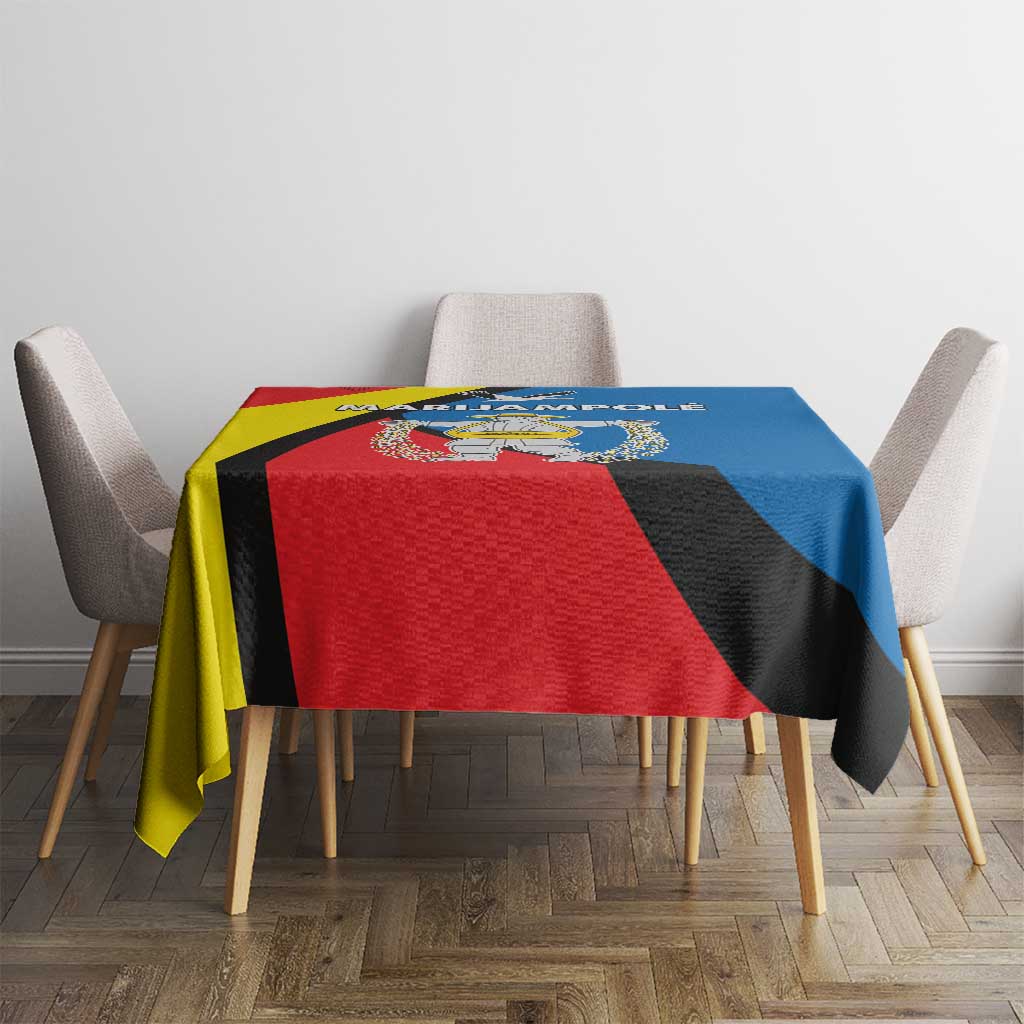 Square tablecloth with red, blue, and yellow diagonal pattern and central emblem.