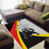 Black area rug with red and yellow stripes and heraldic lion crest artwork