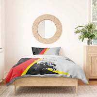 Black bedding set with red and yellow diagonal flag design on duvet and pillow