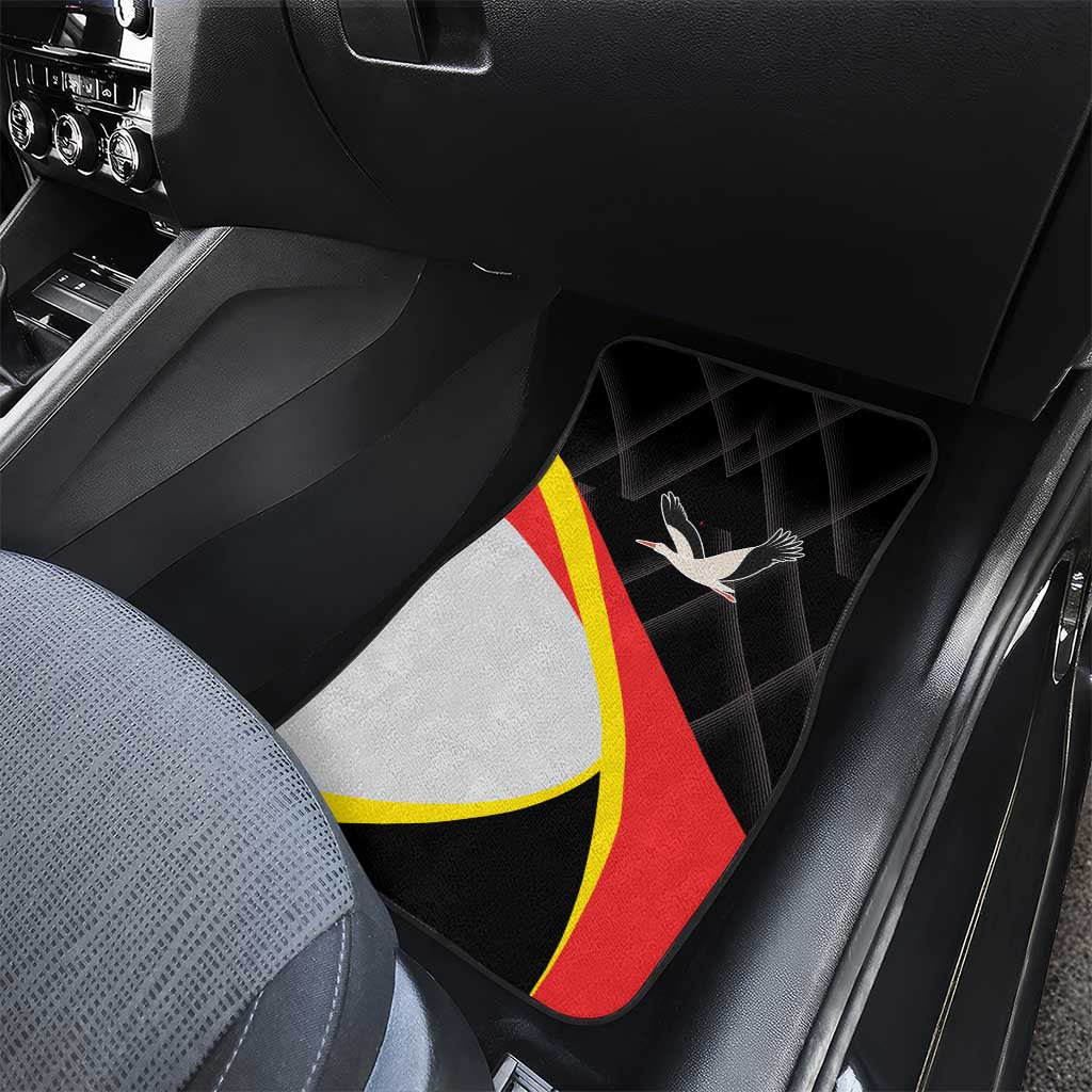 Black car floor mat featuring red-yellow stripe band and white bird emblem