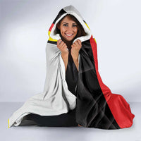 Hooded blanket with red-yellow-black and white panel design and crest graphic