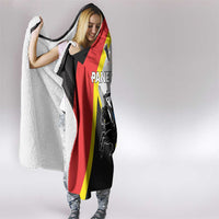 Hooded blanket with crest graphic, red and yellow accents, and dark panel print