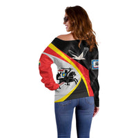 Women’s off-shoulder sweater, black with red-yellow-white stripes and bird emblem on back