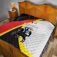 Black and white quilt with crest, red and yellow stripe, and quilted diamond pattern