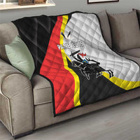 Black quilt with red and white grid pattern and city crest graphic