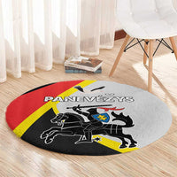 Round gray area rug with red and yellow diagonal stripe and black heraldic crest graphic