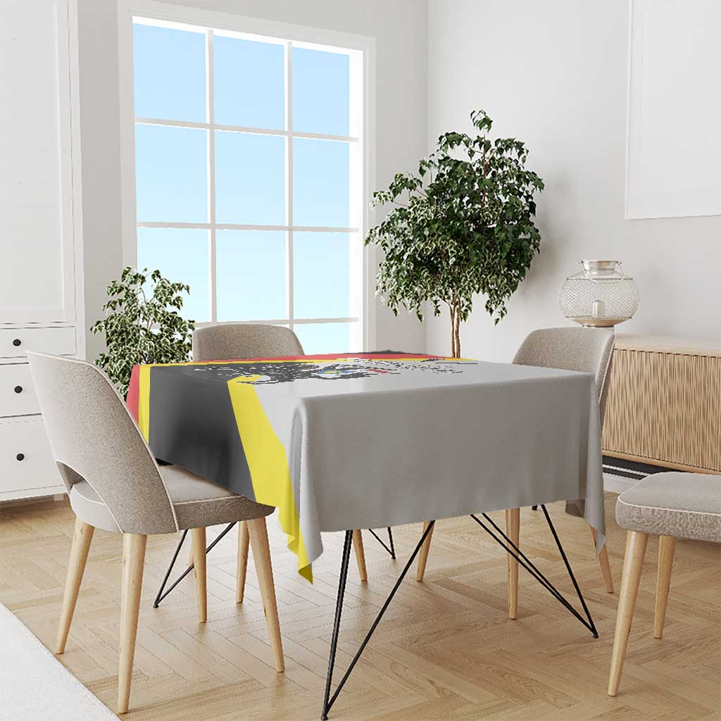 Black tablecloth with red and yellow diagonal stripe design on a dining table