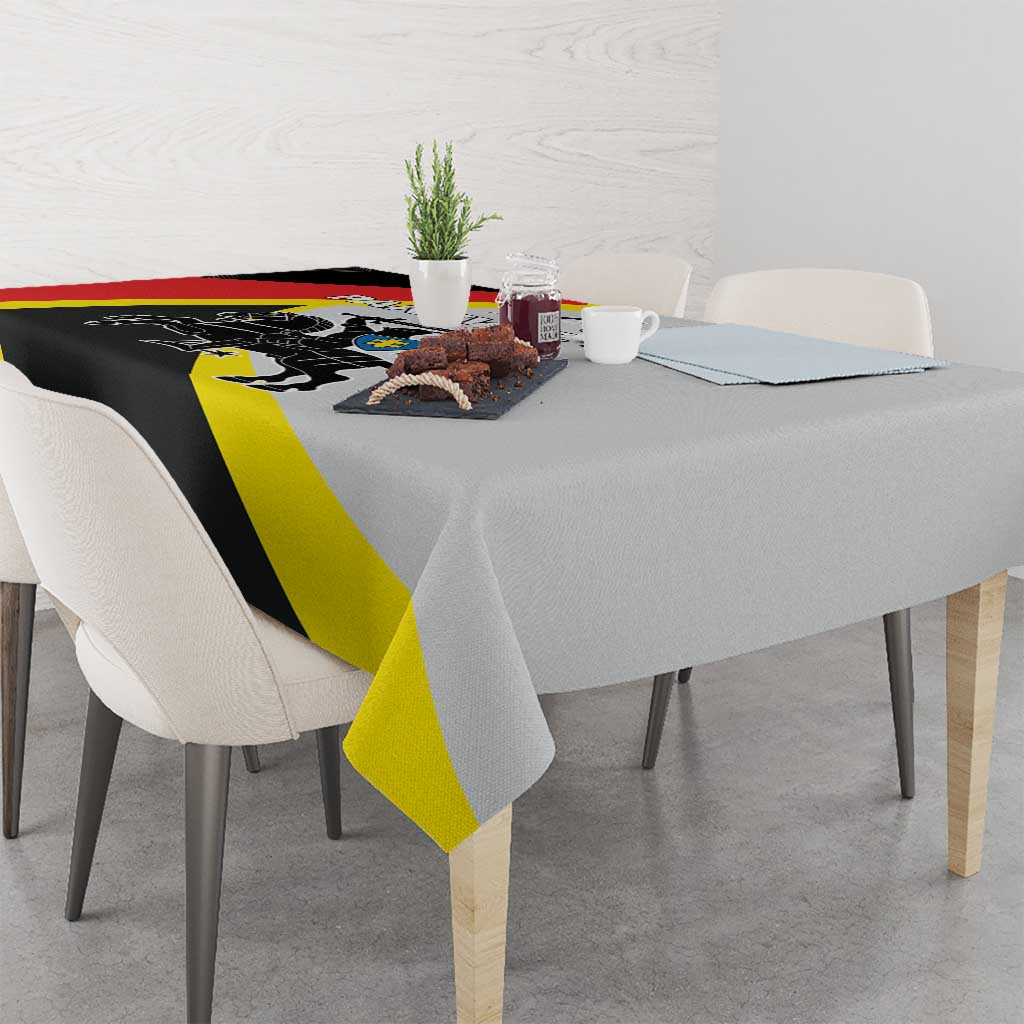 Black tablecloth with red and yellow diagonal stripes draped over dining table