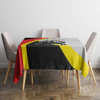 Black tablecloth with red, yellow diagonal stripes and crest graphic on table