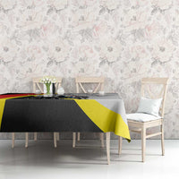 Black tablecloth with red and yellow diagonal stripes and crest graphic on tabletop