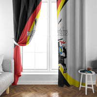 Black and light gray window curtain panels framing a window with crest and diagonal stripes