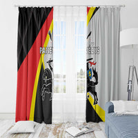 Black and light gray window curtain panels with crest graphic and red-yellow diagonal stripes
