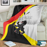 Black, red, and yellow blanket draped over a sofa with running animal graphic