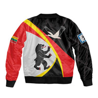 Unisex black bomber jacket with back shield print in red, white, and yellow; ribbed hem