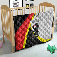 Quilt on a kid’s bed frame in black, red, white and yellow with SIAULIAI crest