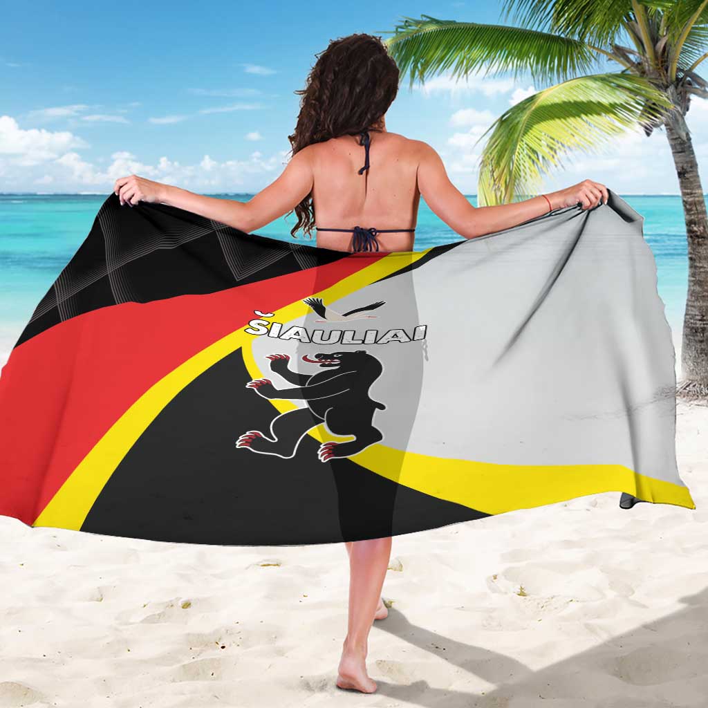 Black-and-white sarong with red diagonal stripe and yellow border, worn as beach wrap