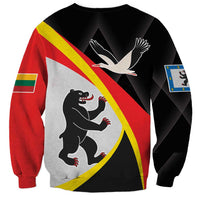 Unisex black sweatshirt back with bird over bear graphic and blue-green flag patch