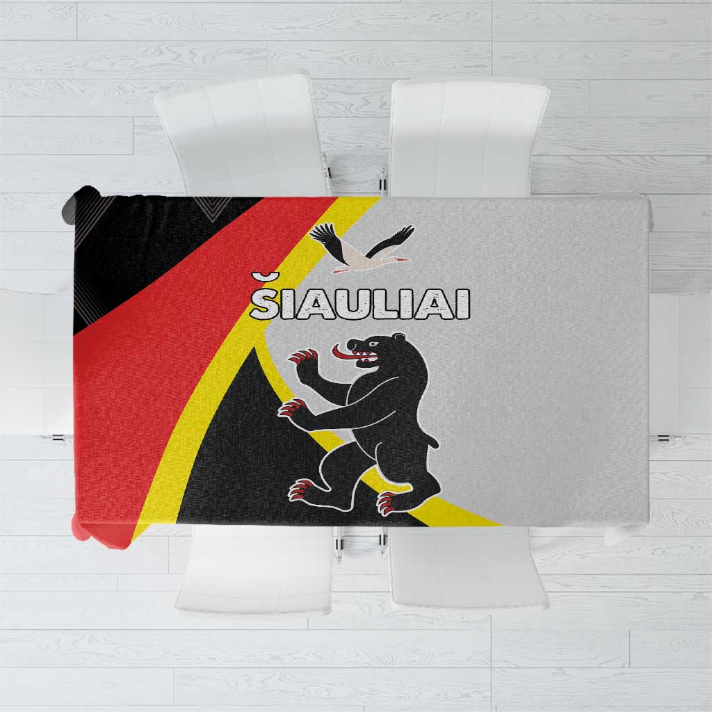Black tablecloth with yellow and red diagonal stripes and central crest graphic