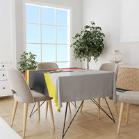 Black tablecloth with yellow diagonal stripe, red accent edge, and crest graphic