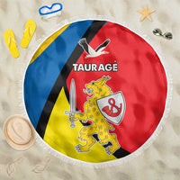 Round beach blanket with fringe, Taurage crest graphic on blue, black, red, and yellow bands.