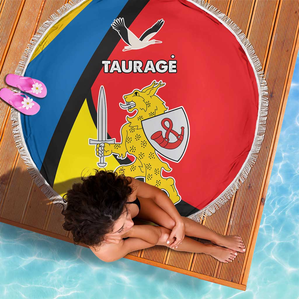 Round beach blanket with fringe showing Taurage crest on blue, black, red, and yellow panels.