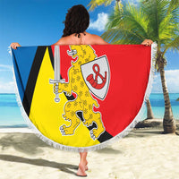 Round beach blanket with fringe featuring Taurage coat of arms in blue, black, red, and yellow.