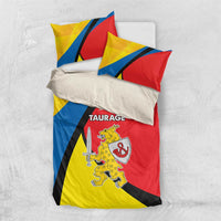 Folded bedding set featuring red, yellow, and blue “TAURAGE” crest and sword graphic