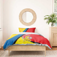 Bedding set blanket with red, yellow, and blue “TAURAGE” crest and shield sword print