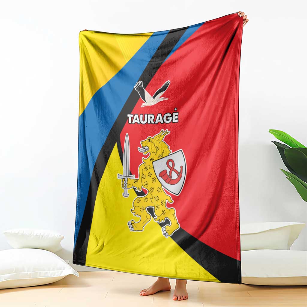 Taurage country blanket draped on the floor, yellow-blue-red flag design with crest