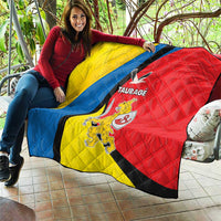 Taurage-themed quilt held outdoors, yellow blue and red colors with black diagonal stripe
