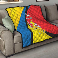 Taurage-themed quilt on sofa, quilted yellow blue red sections with black diagonal stripe