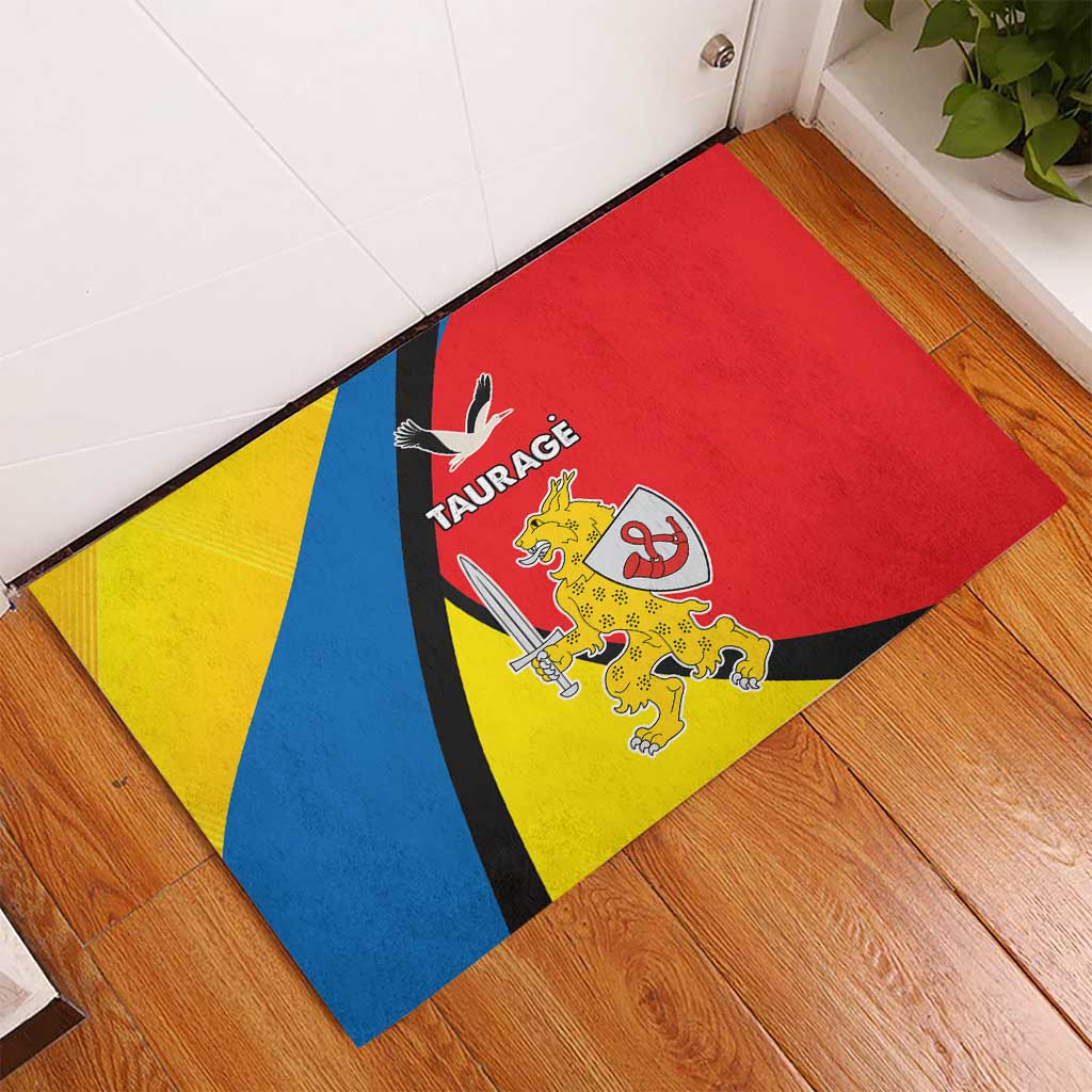 Red rubber doormat with blue and yellow diagonal stripes and Taurage crest graphic