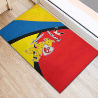 Blue, yellow and red rubber doormat with Taurage emblem and diagonal stripe design