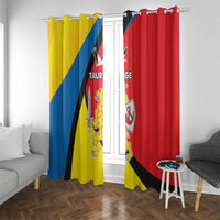 Window curtain panels with yellow and red sections and coat-of-arms style print