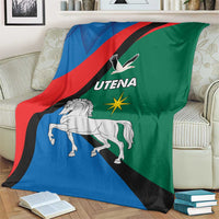 Flag-style blanket spread on sofa showing horse, eagle, and Utena emblem in flag colors