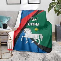 Flag-style blanket draped on sofa with horse graphic and Utena lettering in blue, red, green