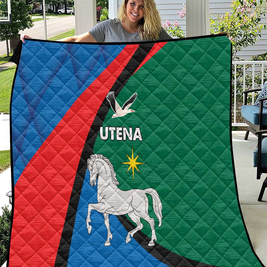 Blue red green quilt blanket with black diagonal stripe, white horse and Utena logo