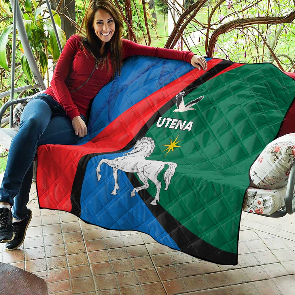 Quilt blanket spread outdoors, blue red green diagonal stripe with horse and Utena logo