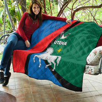 Quilt blanket spread outdoors, blue red green diagonal stripe with horse and Utena logo