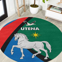 Round blue, red, and green carpet with horse graphic and UTENA crest in center