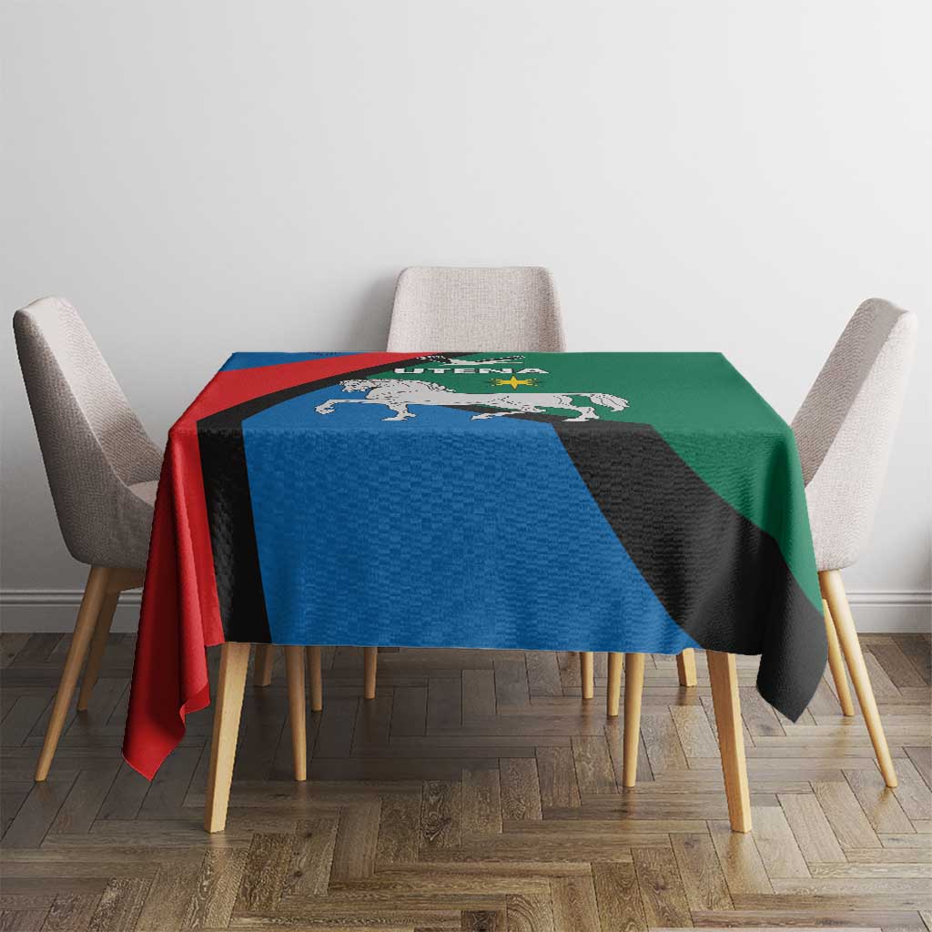 Utena crest tablecloth on dining table with blue red green blocks and black diagonal stripe