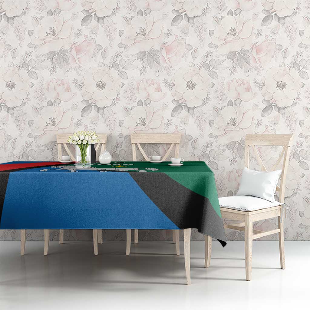 Utena design tablecloth with horse crest and blue red green colors over dining table