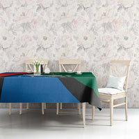 Utena design tablecloth with horse crest and blue red green colors over dining table