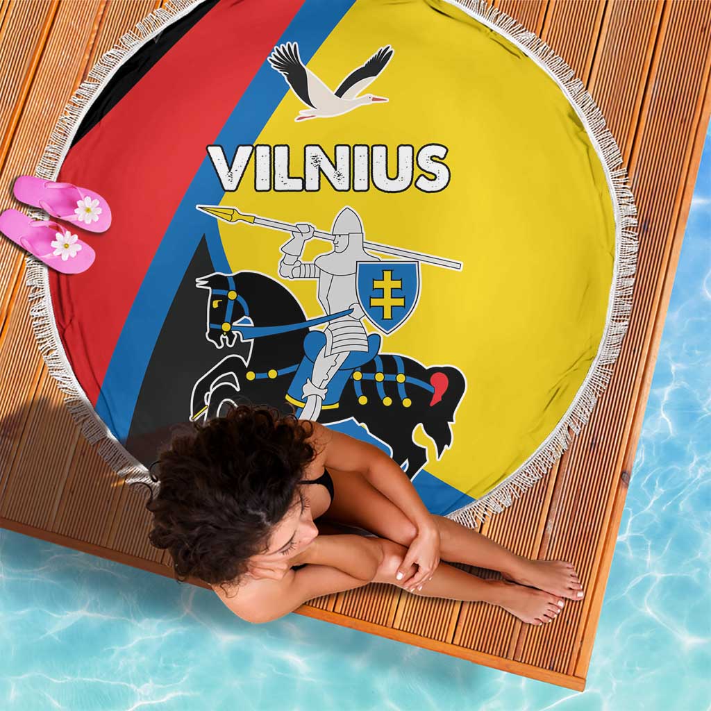 Round beach blanket with fringe, Vilnius logo and rider graphic in yellow, red and blue