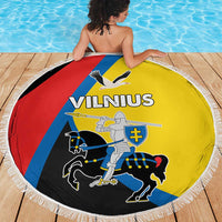 Round beach blanket with fringe, centered Vilnius graphic on yellow, red, blue and black